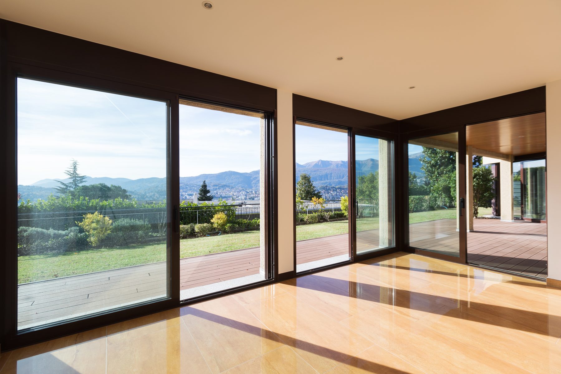 Empty living room, sunlight through large sliding glass doors